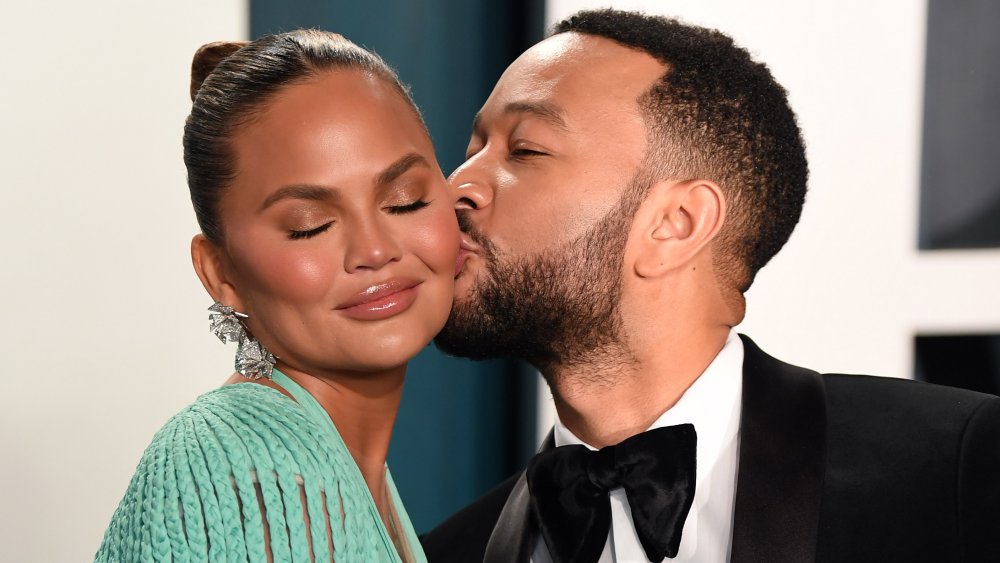 John Legend kissing Chrissy Teigen on the cheek