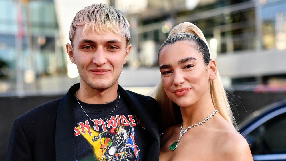 Anwar Hadid, Dua Lipa posing and smiling together with their arms around each other