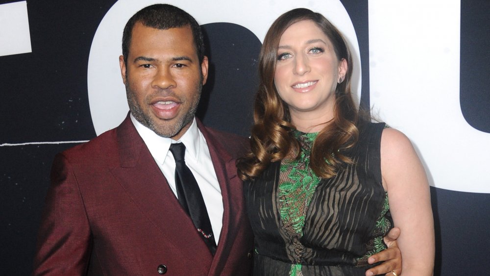 Jordan Peele en costume marron, Chelsea Peretti dans une robe verte et noire