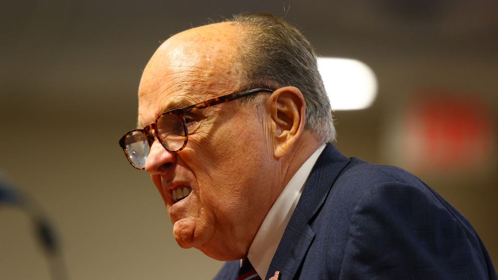 Rudy Giuliani plissant les yeux avec sa bouche ouverte