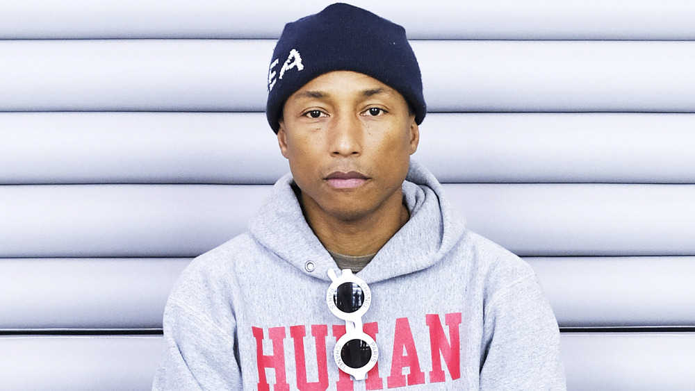 Pharrell Williams assis et regardant la caméra