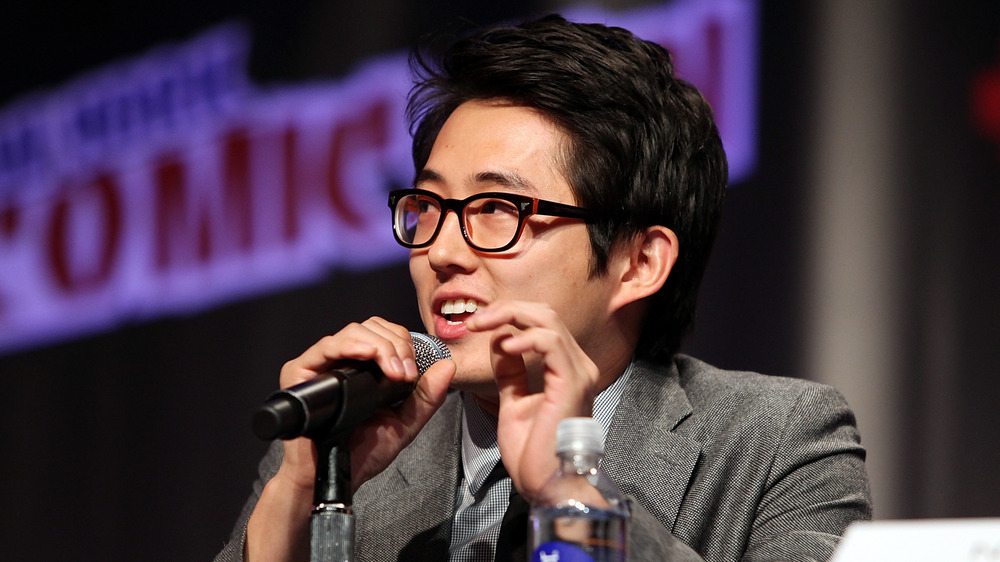 Steven Yeun parlant dans un micro au New York Comic Con