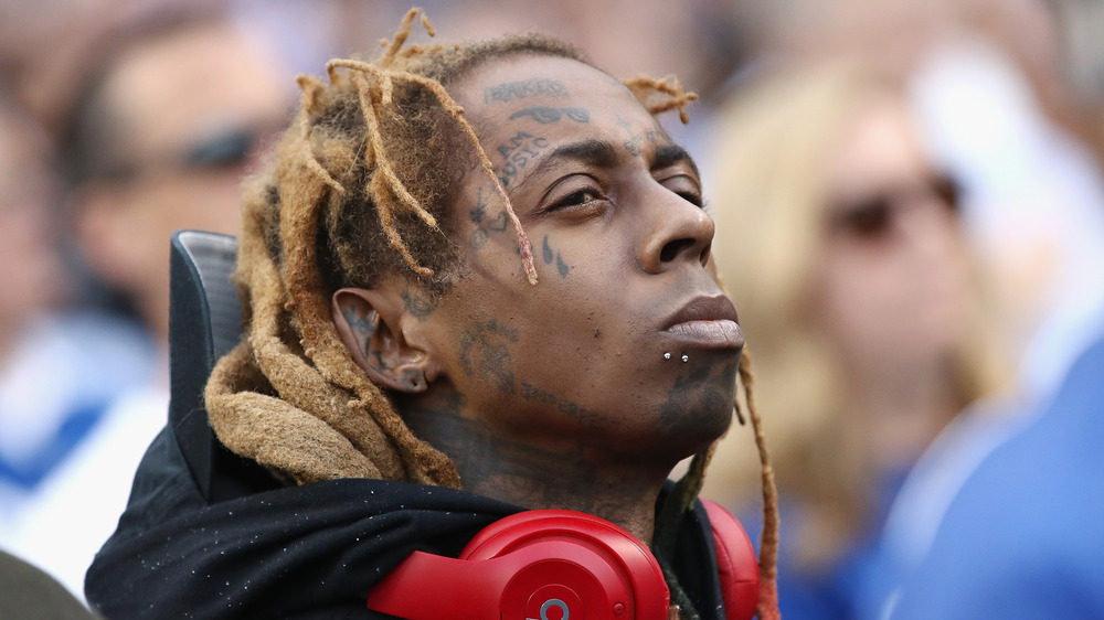 Lil Wayne à la recherche avec des écouteurs rouges autour de son cou