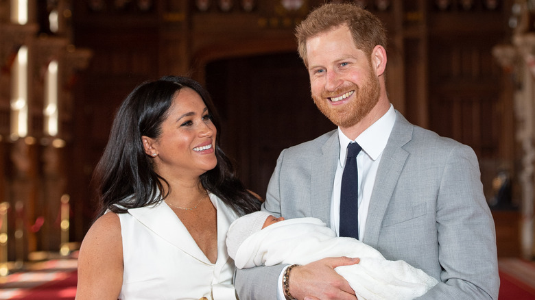 Meghan Markle et le prince Harry souriant tenant leur fils Archie