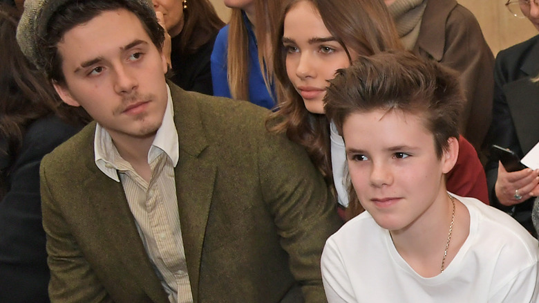 Brooklyn and Cruz Beckham at a fashion show 