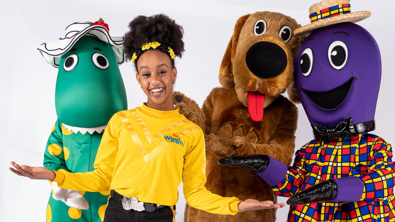 Tsehay Hawkins posing with Wiggles characters