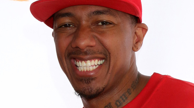 Nick Cannon portant un chapeau rouge et une chemise rouge 