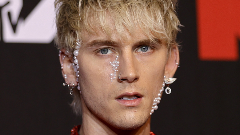 Machine Gun Kelly portant des perles sur le visage