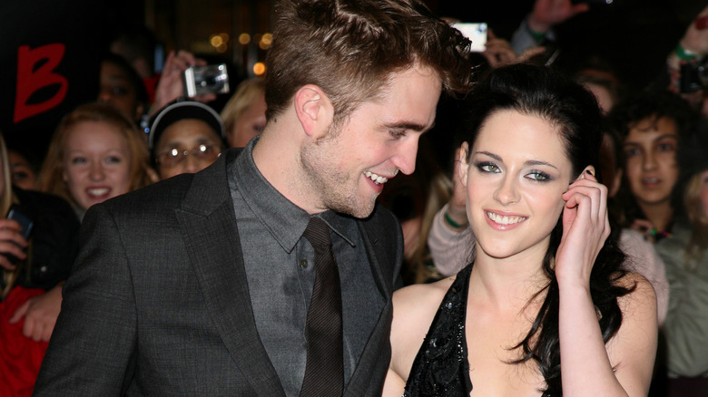 Robert Pattinson souriant à Kristen Stewart sur le tapis rouge 