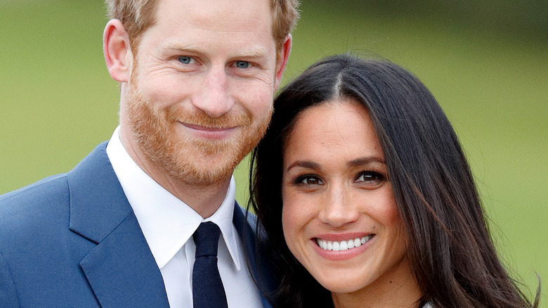 Le prince Harry et Meghan Markle sourient