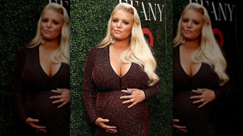 Jessica Simpson berçant son baby bump, posant à l'extérieur