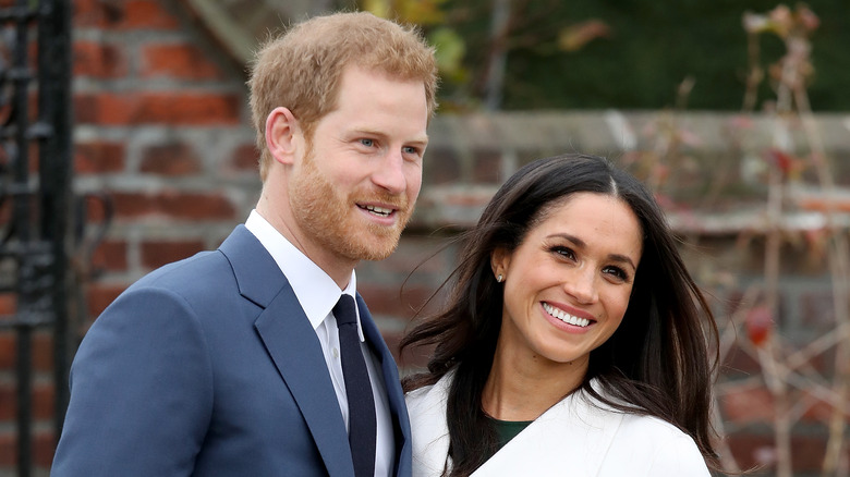 Le prince Harry et Meghan Markle sourient