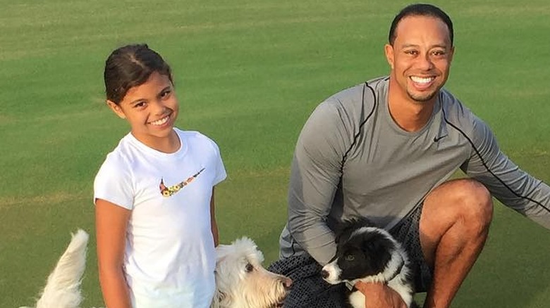 Sam Alexis Woods et Tiger Woods souriant