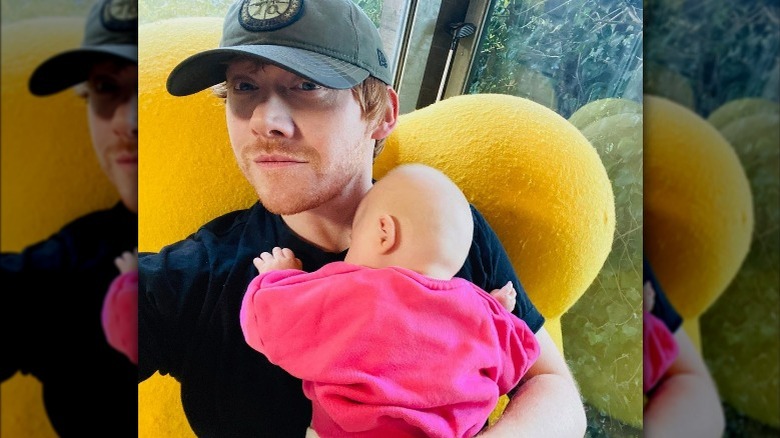 Rupert Grint tenant sa petite fille