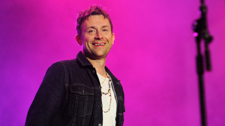 Damon Albarn en train de jouer, souriant