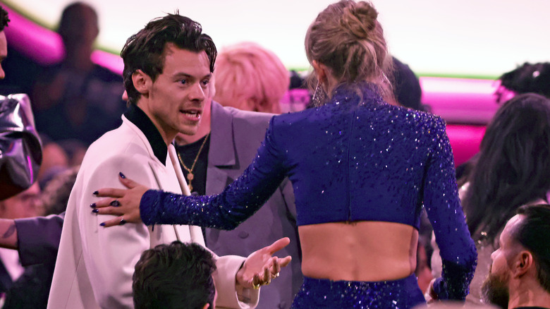 Taylor Swift touchant le bras de Harry Styles