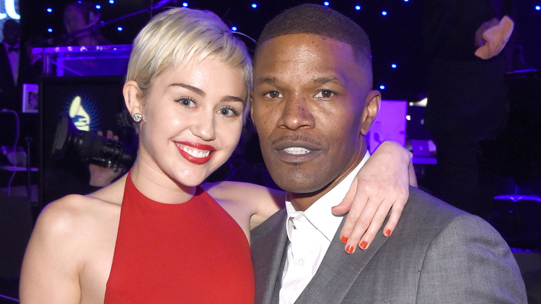 Miley Cyrus avec un bras autour de Jamie Foxx