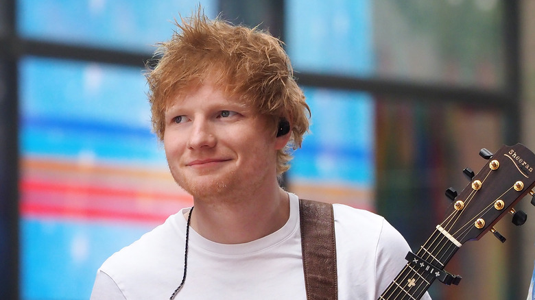 Ed Sheeran souriant avec une guitare