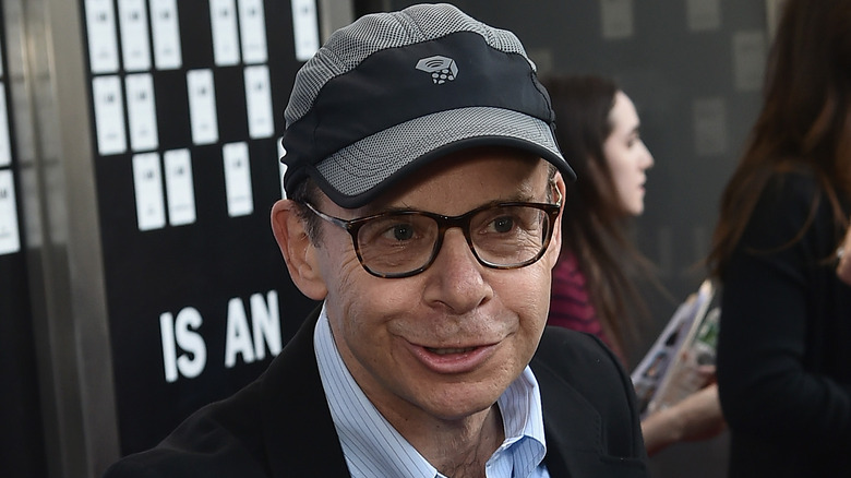 Rick Moranis smiling and talking