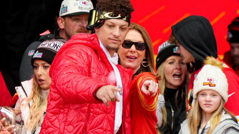 Patrick et Randi Mahomes debout côte à côte et pointant du doigt