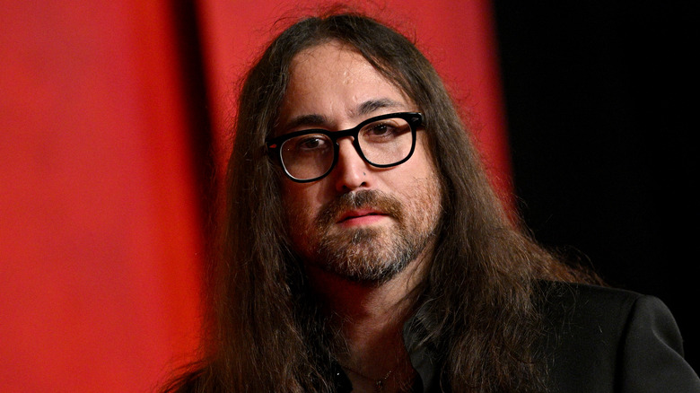 Sean Ono Lennon portant un costume noir et des lunettes à monture noire