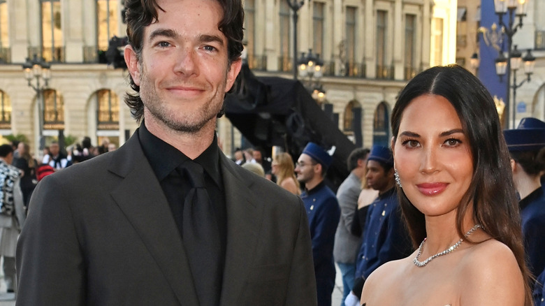 John Mulaney et Olivia Munn posant dehors lors d'un événement